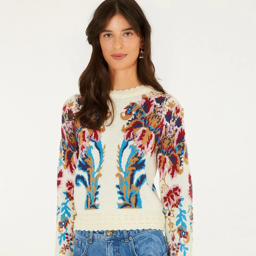 A model wearing the Farm Rio Arabesque Knit Sweater, cream with colorful embroidered florals